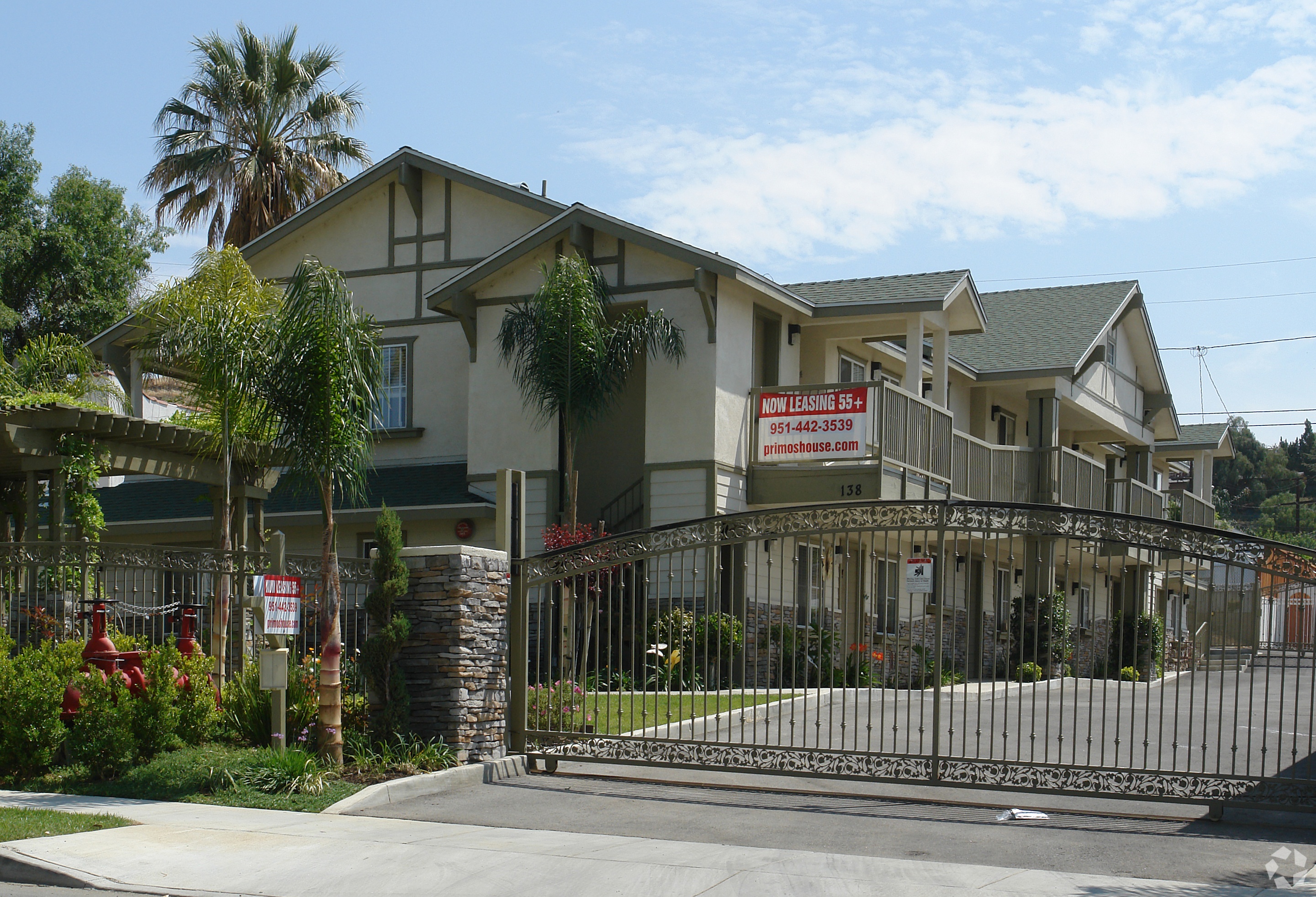A gated community with a sign that says "New Home Open House".